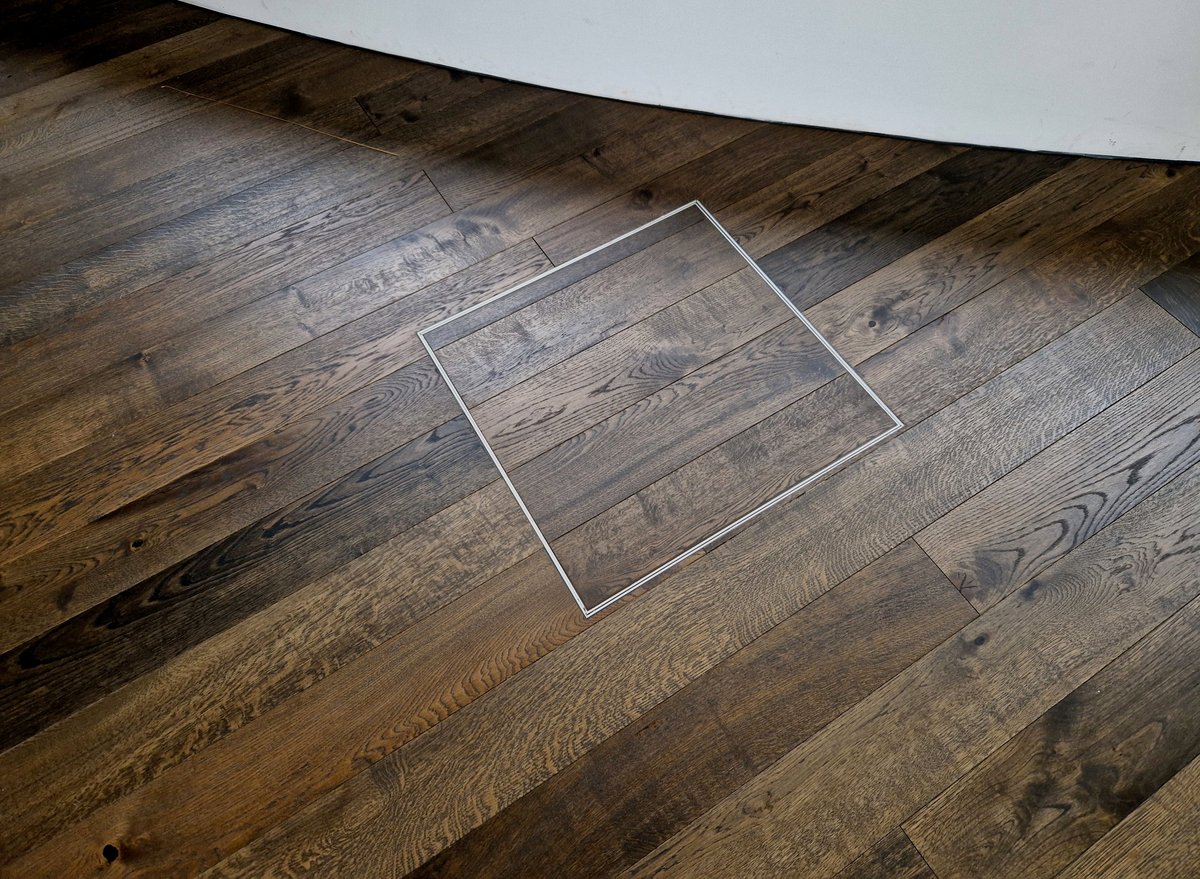 hatch in the floor hides the slots for connecting to the mains