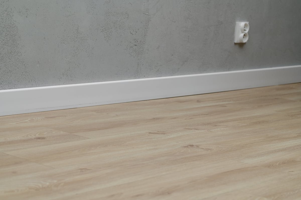 Interior finishing, laminate flooring and skirting board close-up